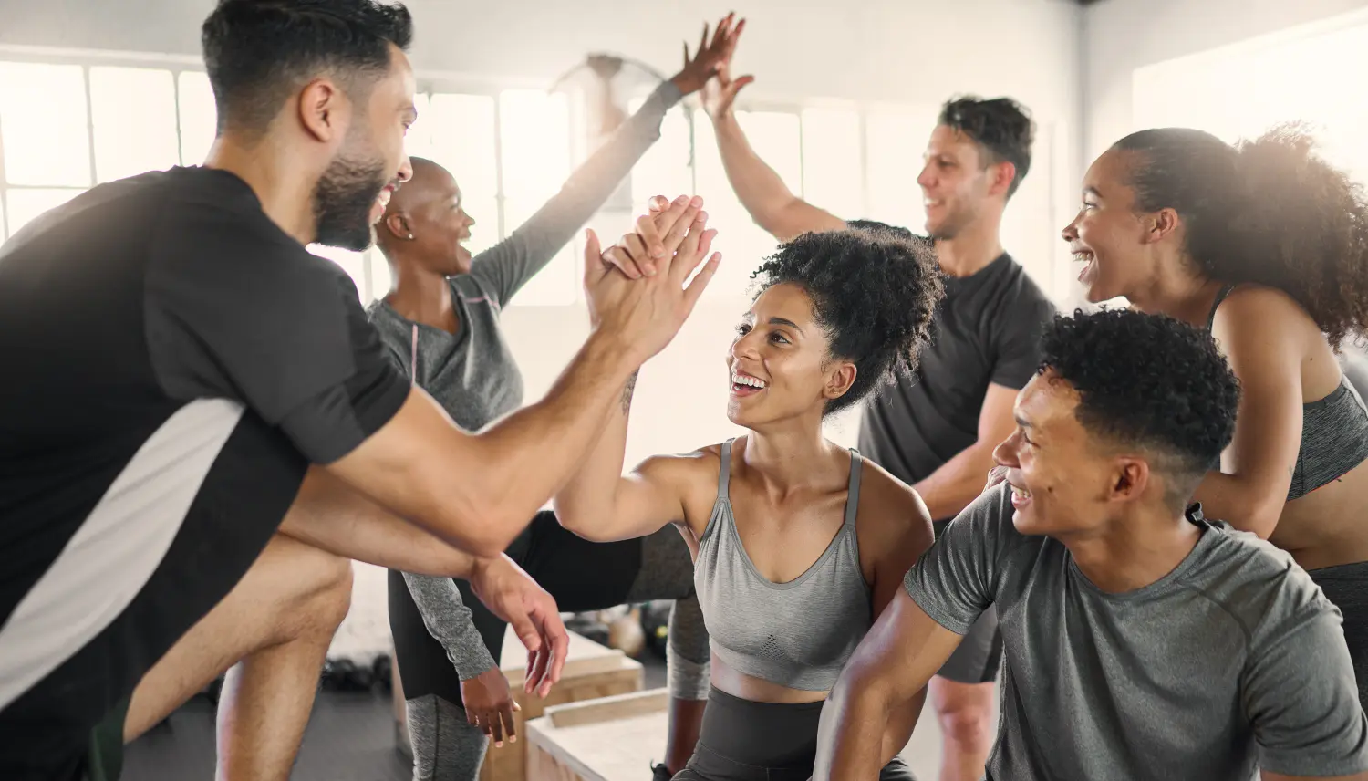 Fitness, High Five und Gruppe im Fitnessstudio zur Feier von Fitnesszielen, Erfolgen und Erfolgen